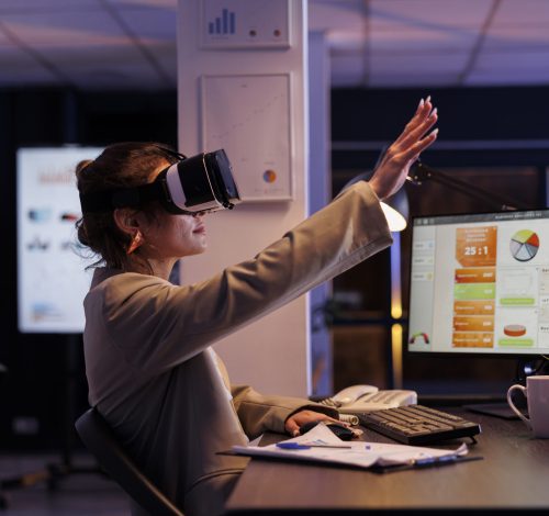 Executive manager wearing virtual reality headset, analyzing financial growth report using hologram in startup office. Businesswoman working late at night at company startegy. Technology concept