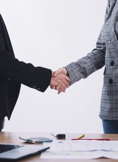 people-shaking-hands-near-table